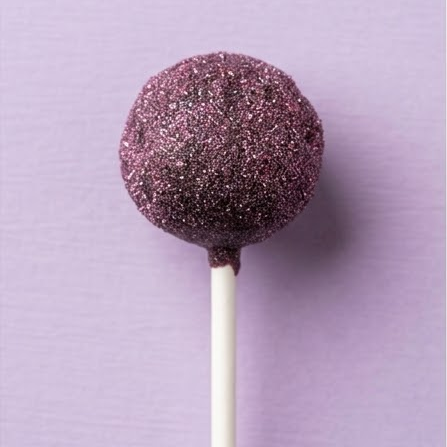 Cake pops drying on parchment in a home kitchen